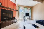 Wood burning fireplace, sliding glass doors to the balcony and Smart TV
